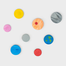 Set of eight round solar system themed erasers in yellow, pink, orange, gray, and blue