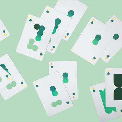 Solo Mello playing cards: overlapping white cards with green clover symbols