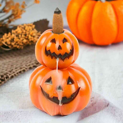 Stacked pumpkin jack-o-lantern backflow incense burner with incense stick and smoke