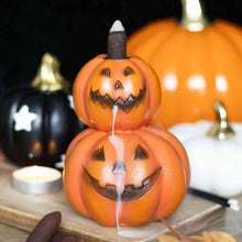 Stacked pumpkin jack-o-lantern backflow incense burner with smoke stream from top