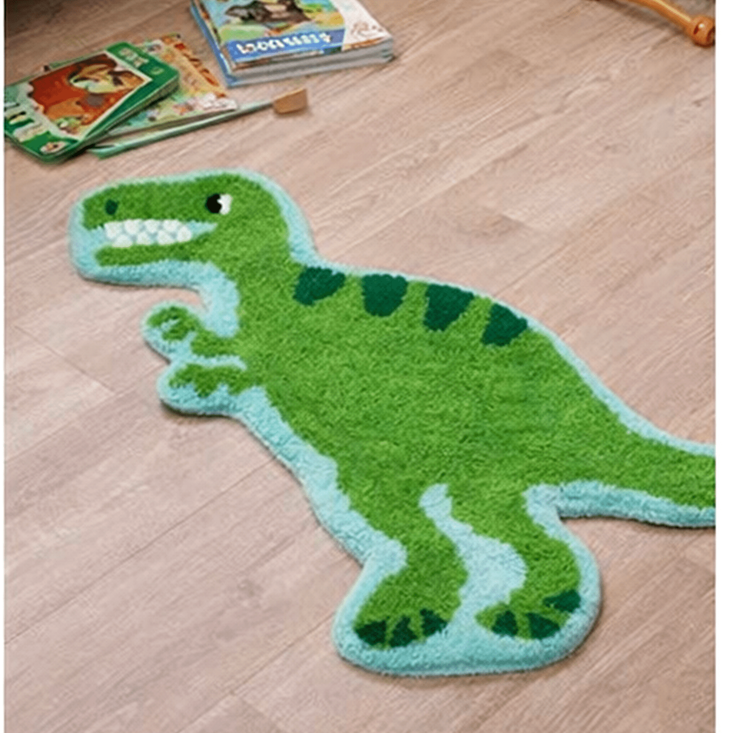 Green T-Rex dinosaur rug with light blue trim, shown on wood floor