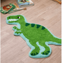 Green T-Rex dinosaur rug with light blue trim, shown on wood floor