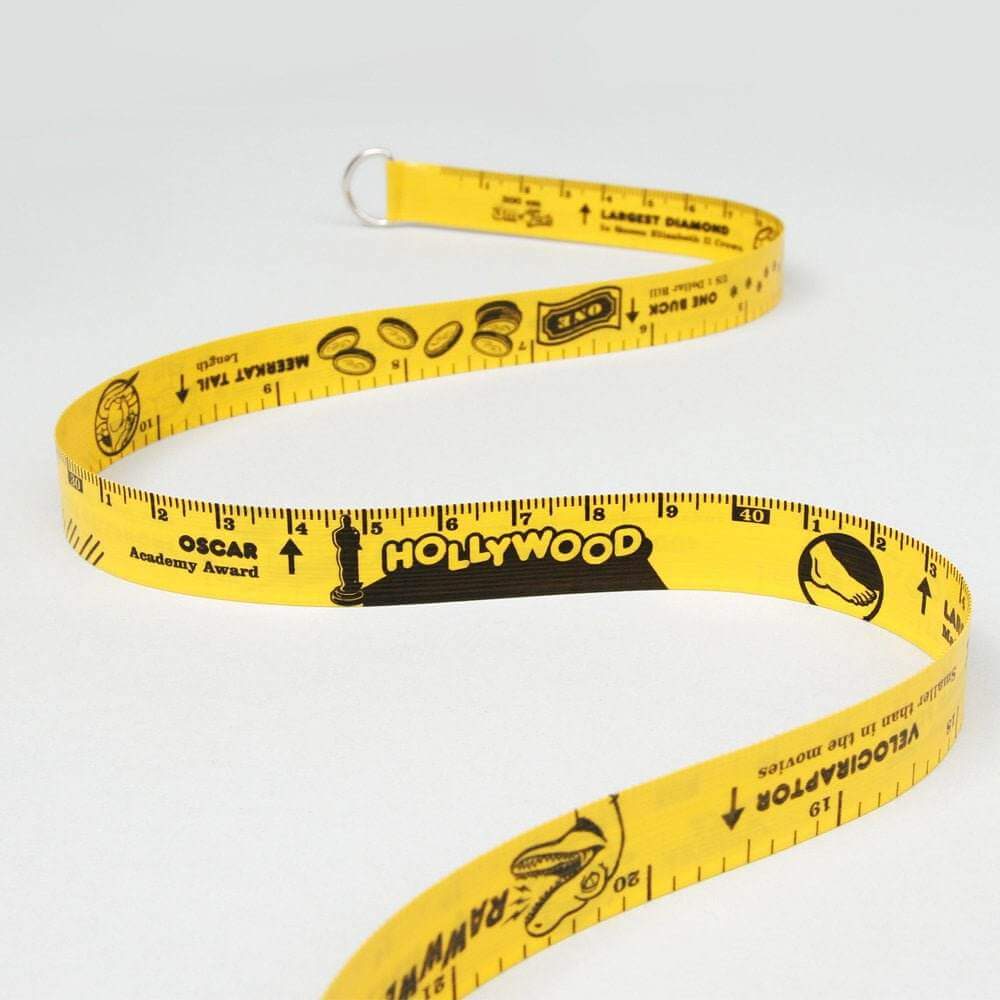 Yellow retractable tape measure with measurement markings and themed graphics