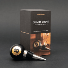 Black 8-ball bottle stopper with stainless spout, shown with retail box