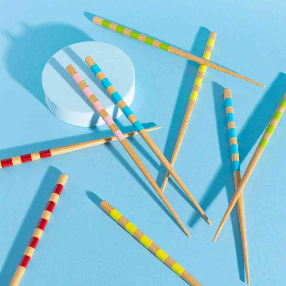 Set of 5 bamboo chopsticks scattered, featuring multicolor striped barrels