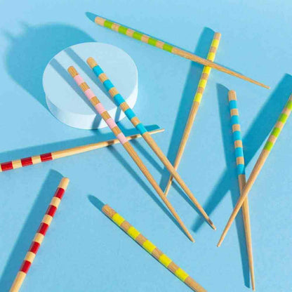Set of 5 bamboo chopsticks scattered, featuring multicolor striped barrels