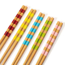 Set of 5 bamboo chopsticks with vibrant red, yellow, and blue striped bands