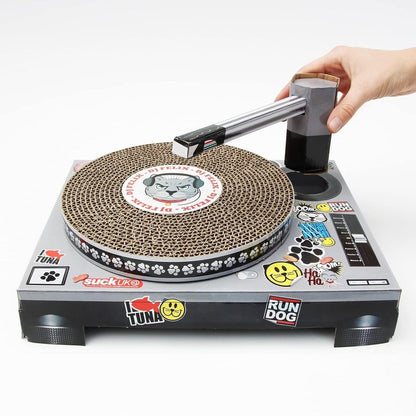 Turntable scratching cat toy with round sisal pad, printed base, and handle
