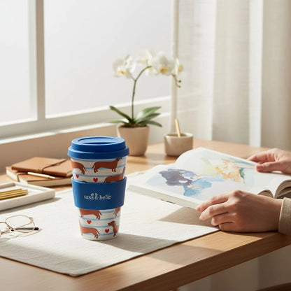 Travel coffee cup with dachshund pattern and blue lid