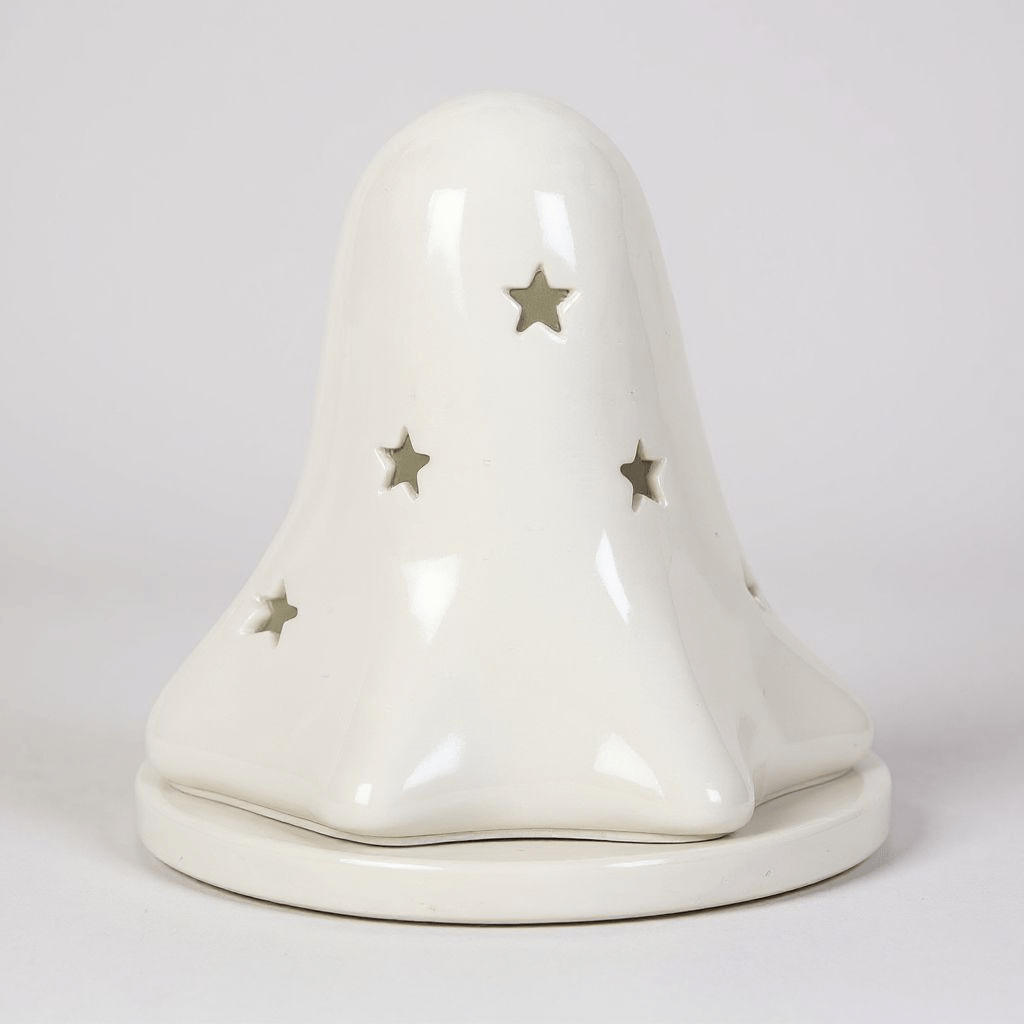 White ceramic ghost tealight holder with star accents and hollow eye cutouts on base