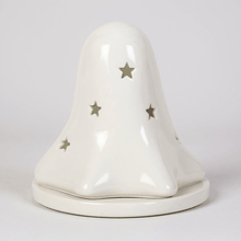 White ceramic ghost tealight holder with star accents and hollow eye cutouts on base
