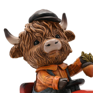 The Fashion Gift Shop: Highland Cow sits happily on a tractor, creating a charming rural scene by Country Living, Animal Ornament