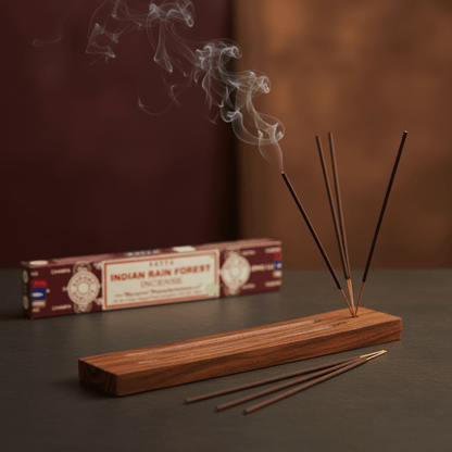 Incense sticks burning with smoke beside Satya Indian Rain Forest box