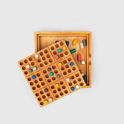 Wooden colour sudoku game set with board in case and colored pegs on tray