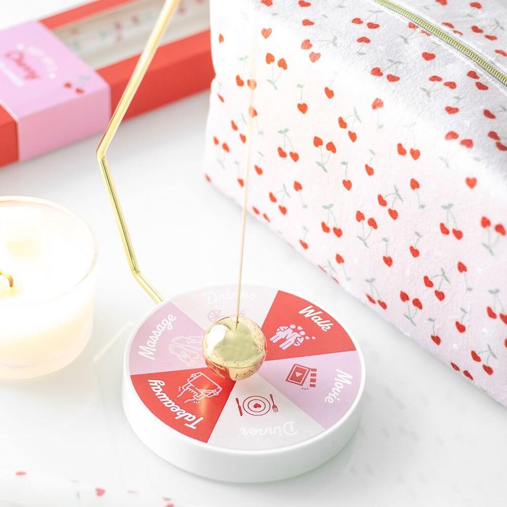 Heart-pattern pendulum decision wheel with gold ball on a swinging stand