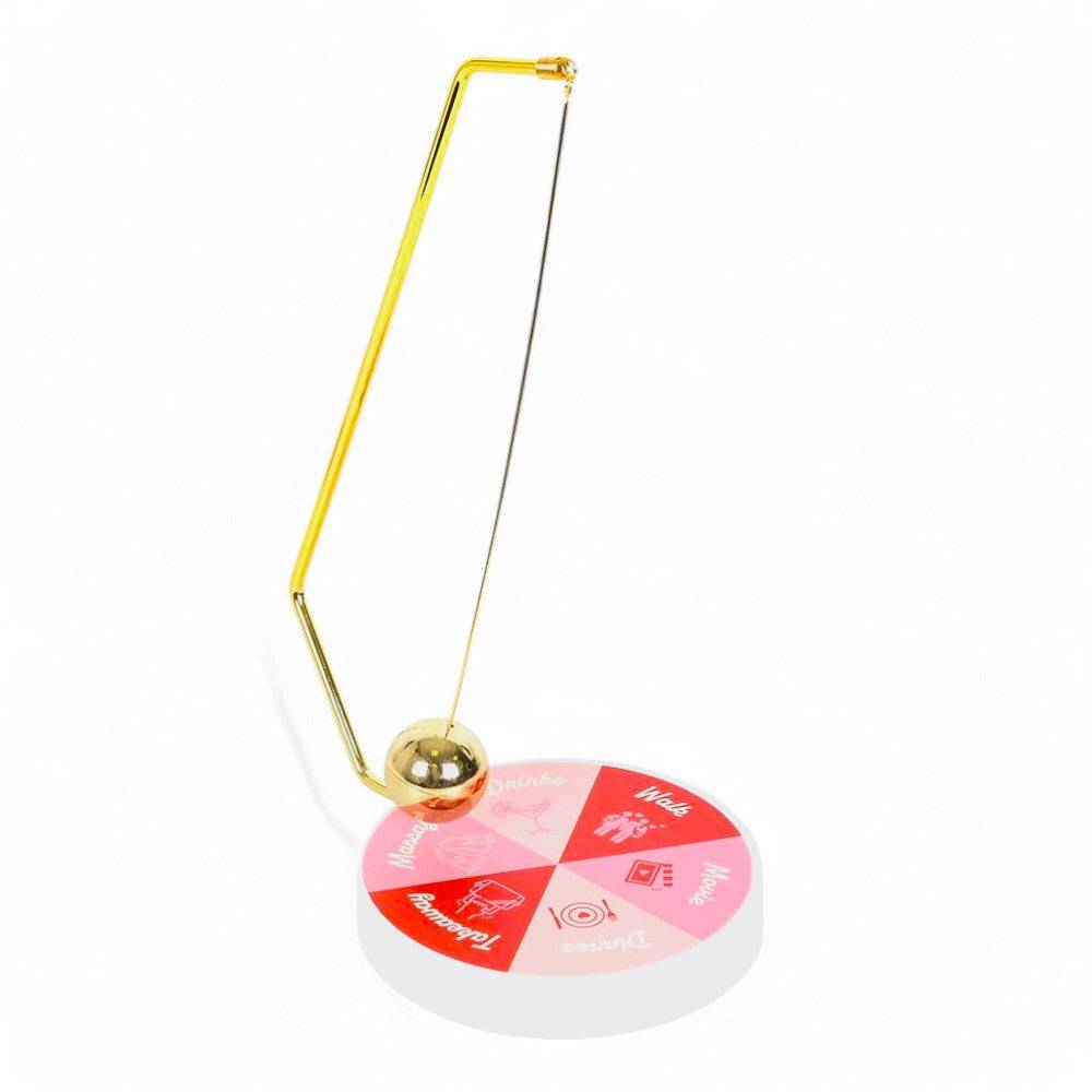 Gold pendulum stand with hanging ball and round game wheel