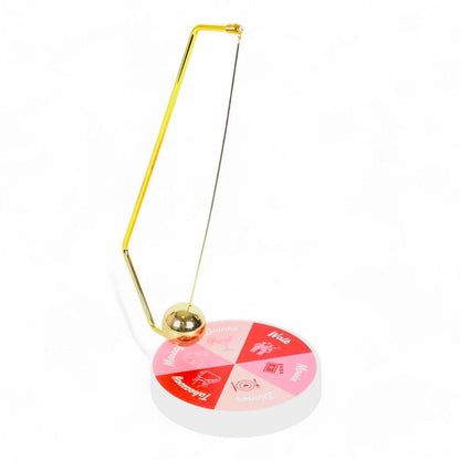 Gold pendulum stand with hanging ball and round game wheel