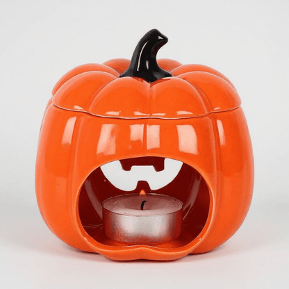 Orange jack-o-lantern oil burner with open top and metal tealight cup inside