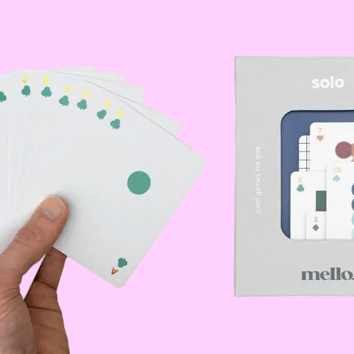 Solo Mello playing cards: hand holds white cards next to boxed deck
