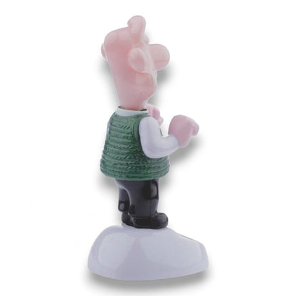 Solar-powered Wallace figurine side view with one arm raised, green sweater and boots