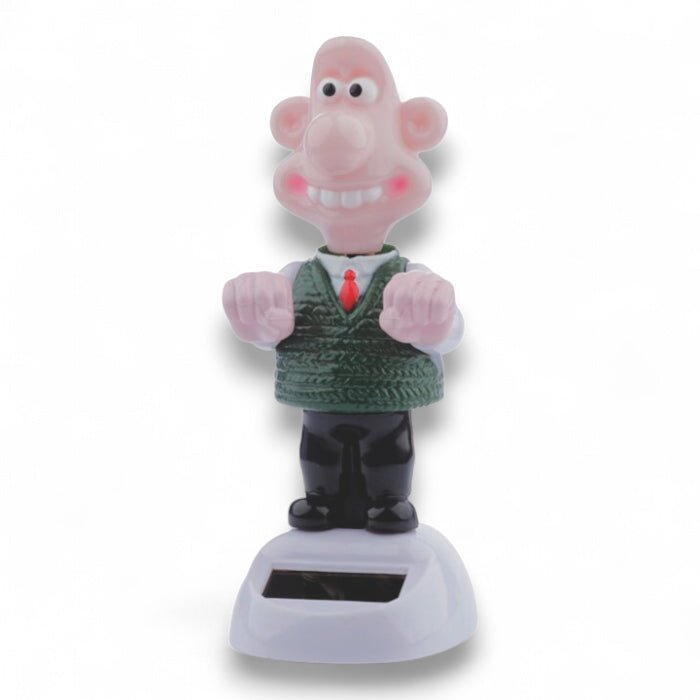 Solar-powered Wallace figurine front view with smiling pink face and green sweater