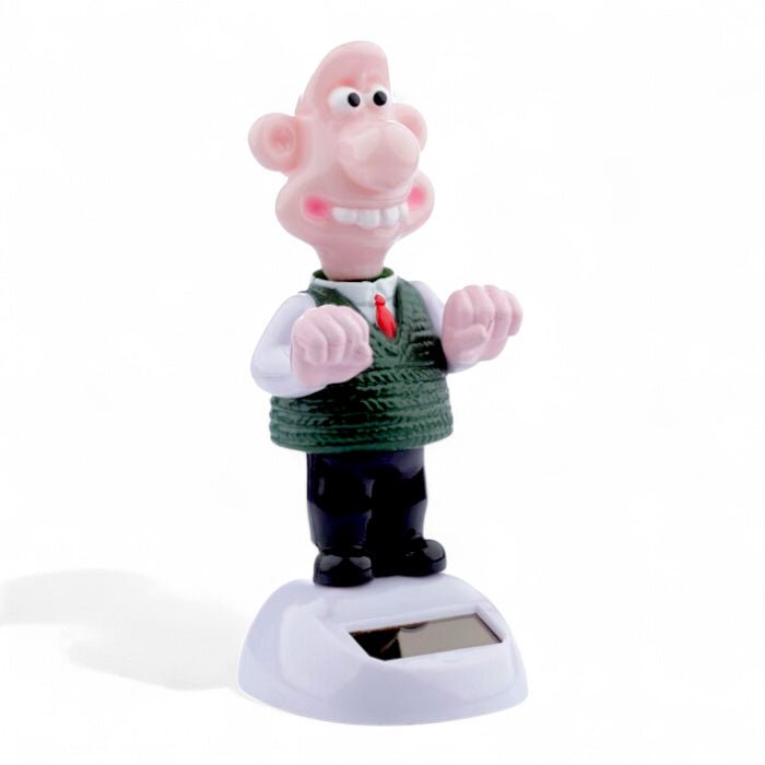 Solar-powered Wallace figurine with pink face, green sweater and black boots