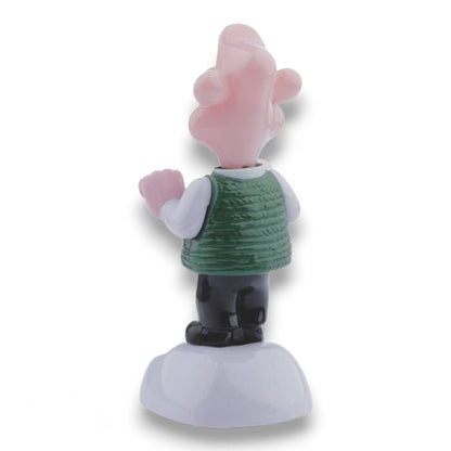 Solar-powered Wallace figurine back view with raised arms and green sweater