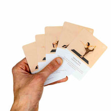 Yoga pose deck cards fanned in hand, showing pose instructions
