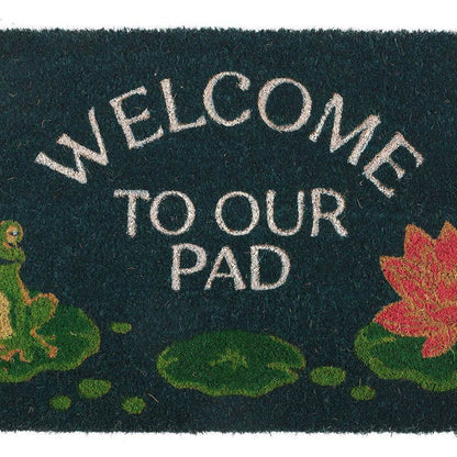 Close-up dark green doormat with Welcome to Our Pad text, frog, and red lily flower