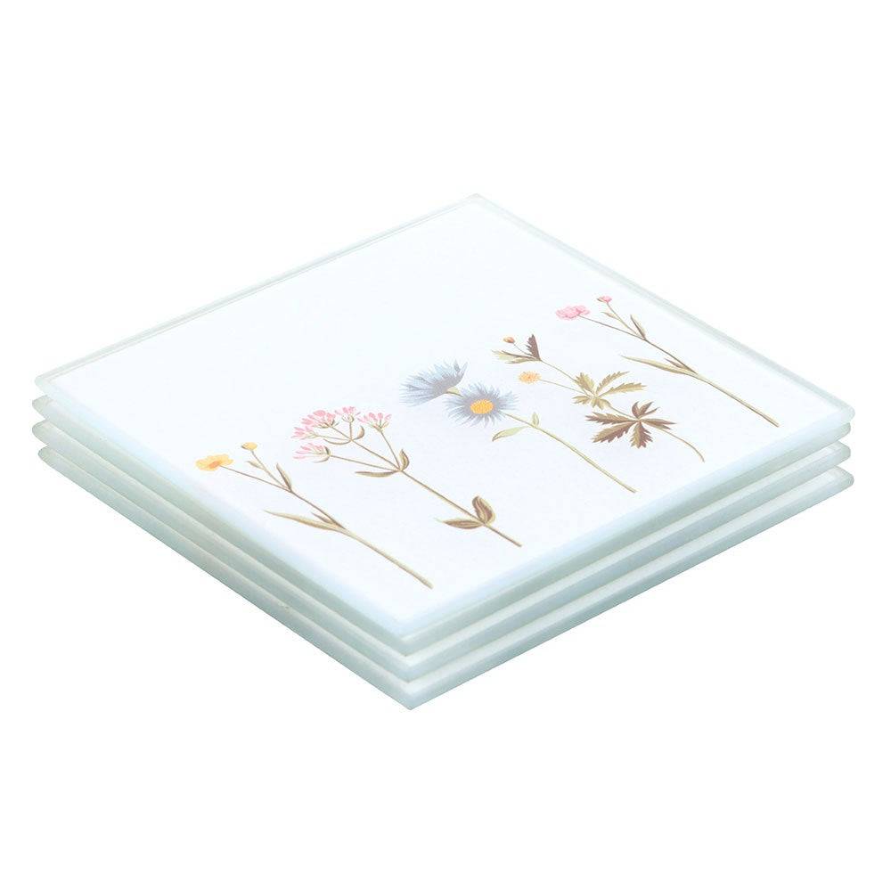 Set of four floral glass coasters, stacked white tiles with botanical wildflower print