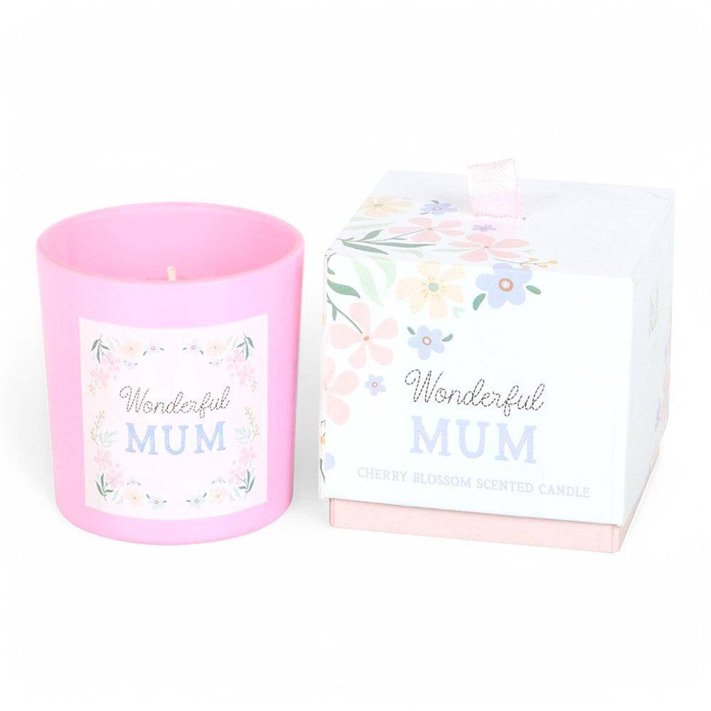 Pink scented candle jar beside white gift box with 'Wonderful Mum' floral design