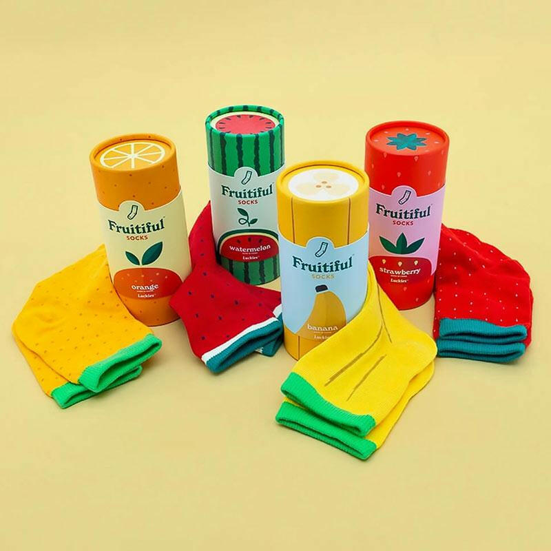 Assorted fruit-themed socks set in colorful canisters, folded socks including watermelon