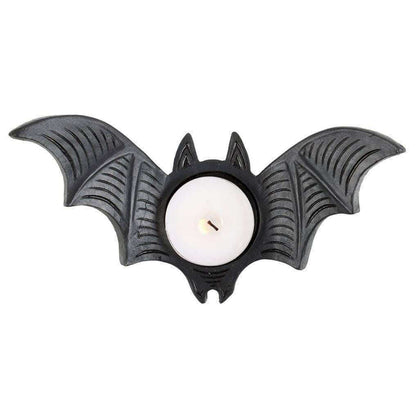 Bat-shaped tealight candle holder with central white candle, black textured wings.