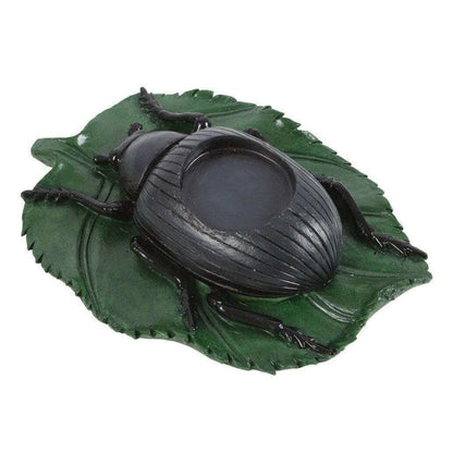 Beetle tealight candle holder viewed from the side, green leaf base and black beetle figurine