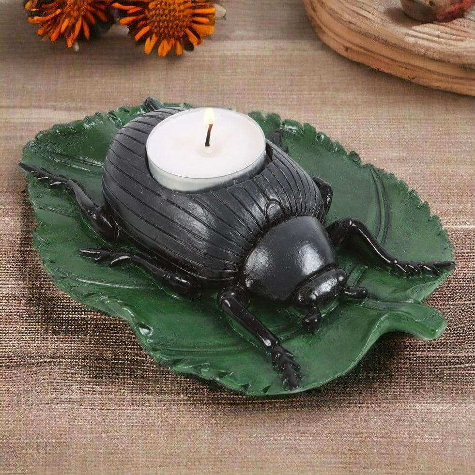 Beetle tealight candle holder with green leaf base and black beetle, holding a white tealight