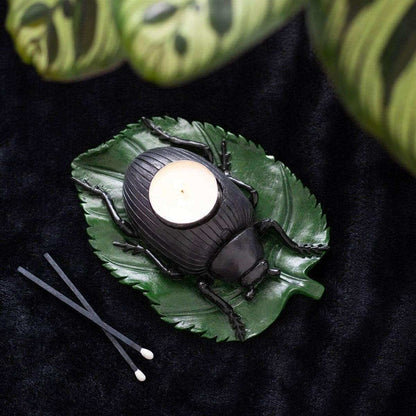 Beetle tealight candle holder with green leaf tray, black beetle, and lit white tealight