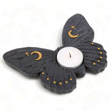 Moth tealight candle holder with layered wings, crescent moon and star details, lit candle flame
