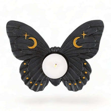 Moth tealight candle holder with dark wings, crescent moon and star accents, round candle cup