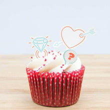 Cake topper decorations set with heart and diamond cutout on a red cupcake