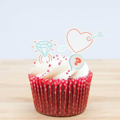 Cake topper decorations set with heart and diamond cutout on a red cupcake