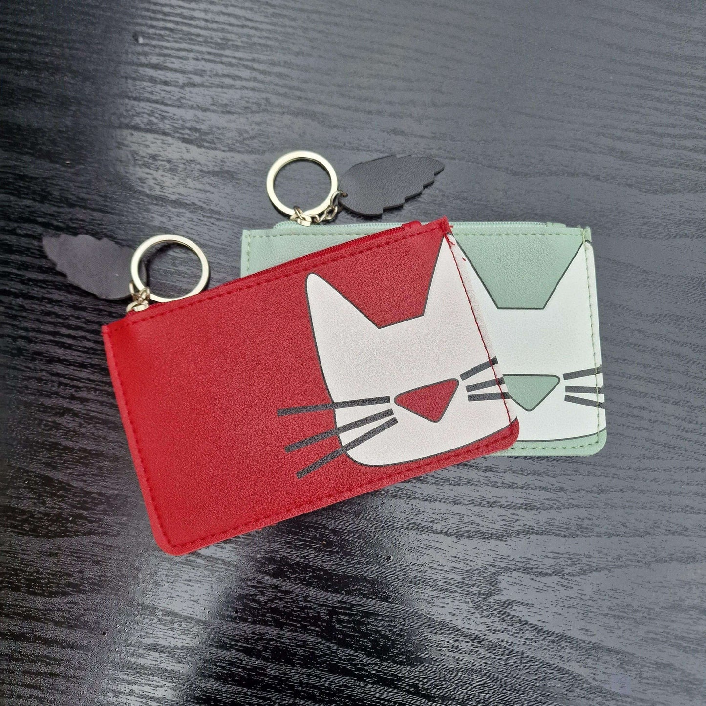 Red cat-face faux leather keyring purse with zipper and white cat face graphic, keyring top