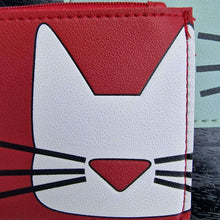 Red faux leather card pouch with white cat face graphic and zipper edge