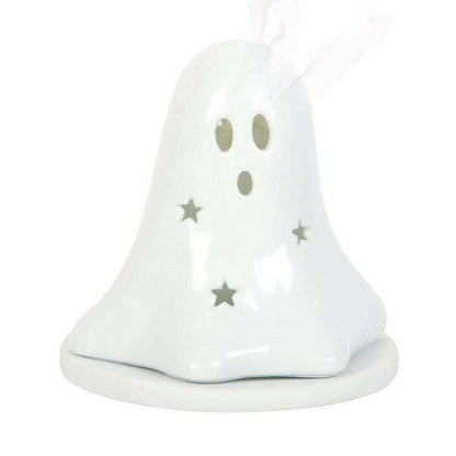 White ceramic ghost tealight holder with hollow face holes and gold star accents