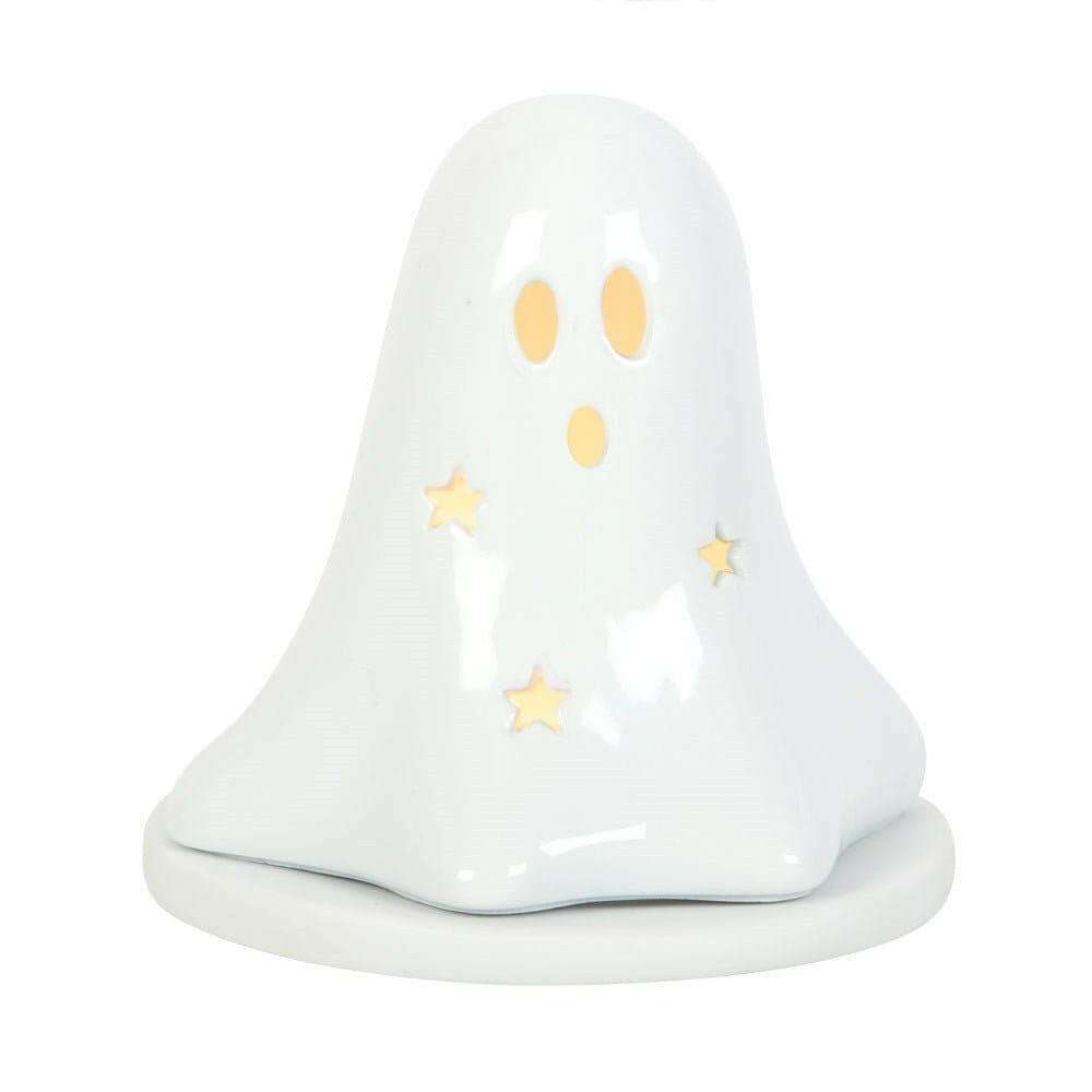 White ceramic ghost tealight holder with orange eyes, gold stars, and smooth domed body