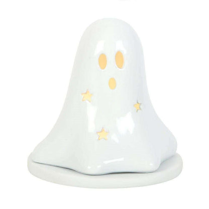 White ceramic ghost tealight holder with orange eyes, gold stars, and smooth domed body