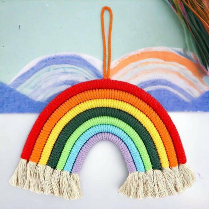 Hanging rainbow room decoration with multicolor knitted arch and beige tassel fringe
