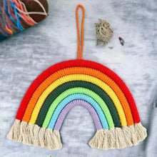 Hanging rainbow room decoration with knitted arch in red, orange, yellow, green and fringe