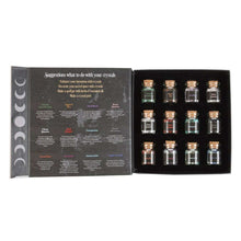 Open crystal chip bottle set in black tray with multiple small labeled glass jars