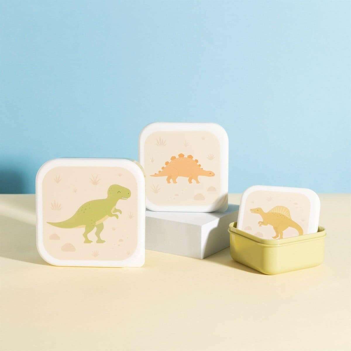 Three dinosaur lunch boxes in olive green and white with square lids and panels