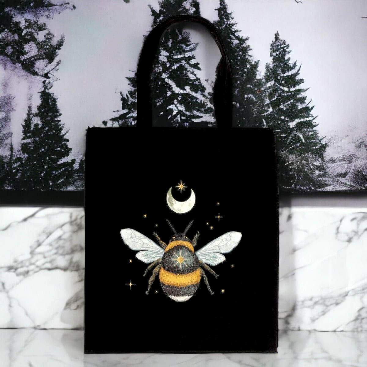 Black cotton tote bag with centered moon-and-bee graphic